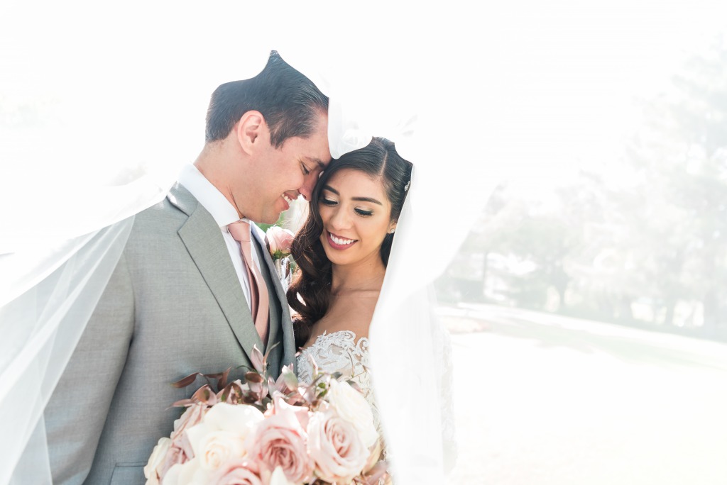 Happy bride and groom capturing a elegant photo at JW Marriott Resort & Spa Las Vegas