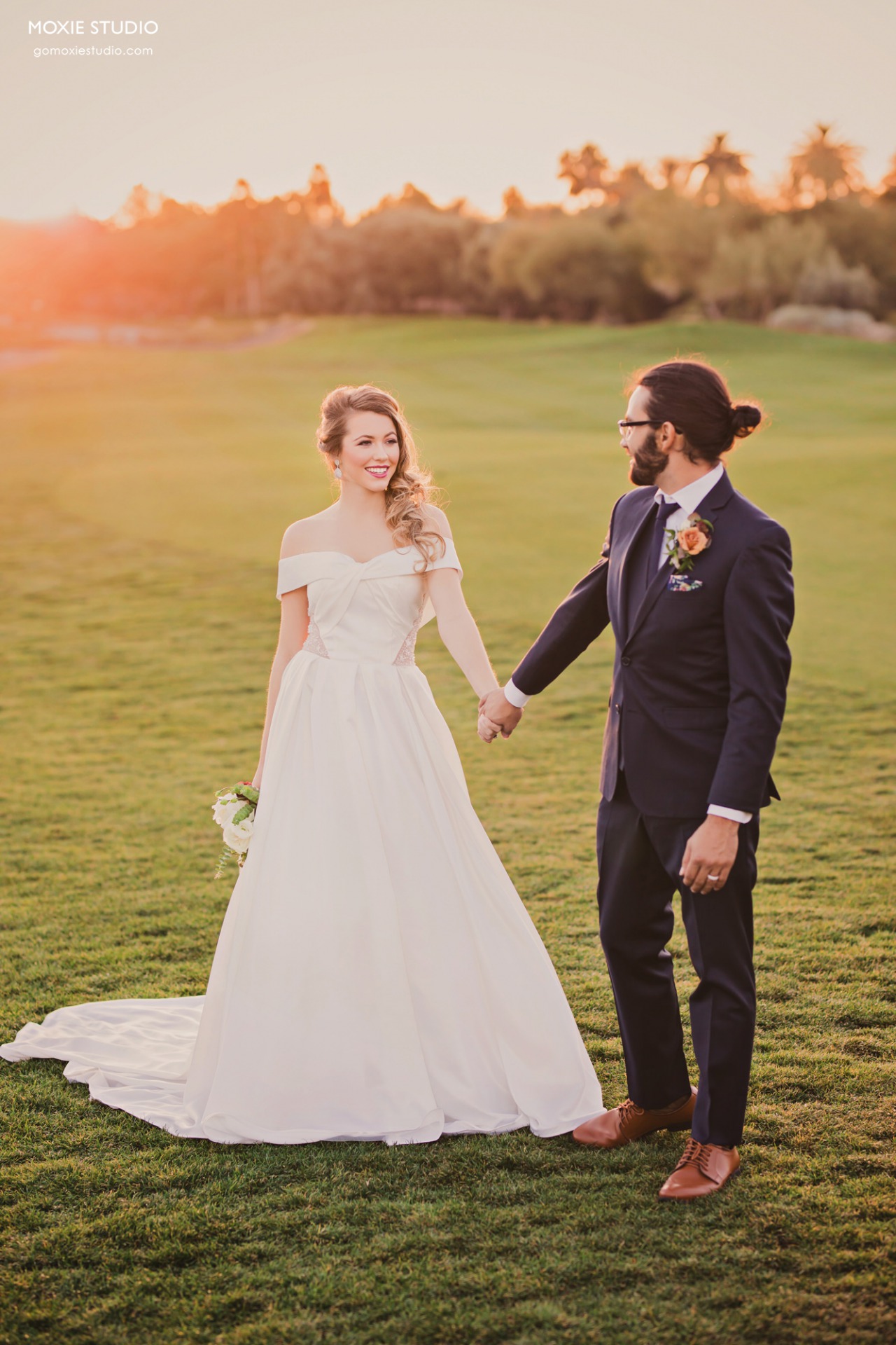 Happy Bride and Groom outside at sunset at DragonRidge Country Club