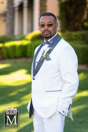 Groom in white and black tux