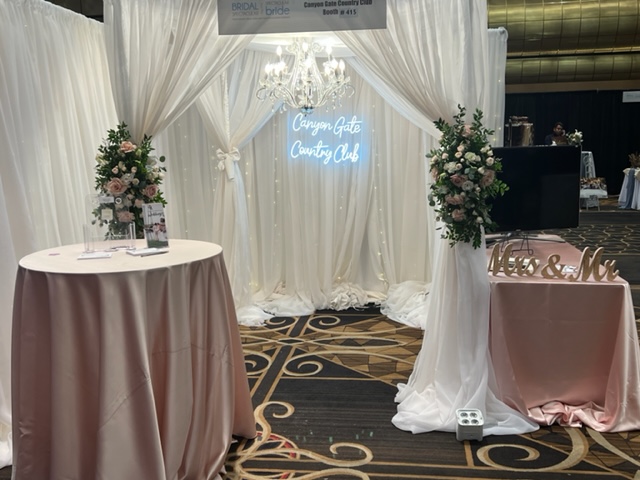 Canyon Gate Country Club's lovely booth in white linens at the Bridal Spectacular Wedding Expo.