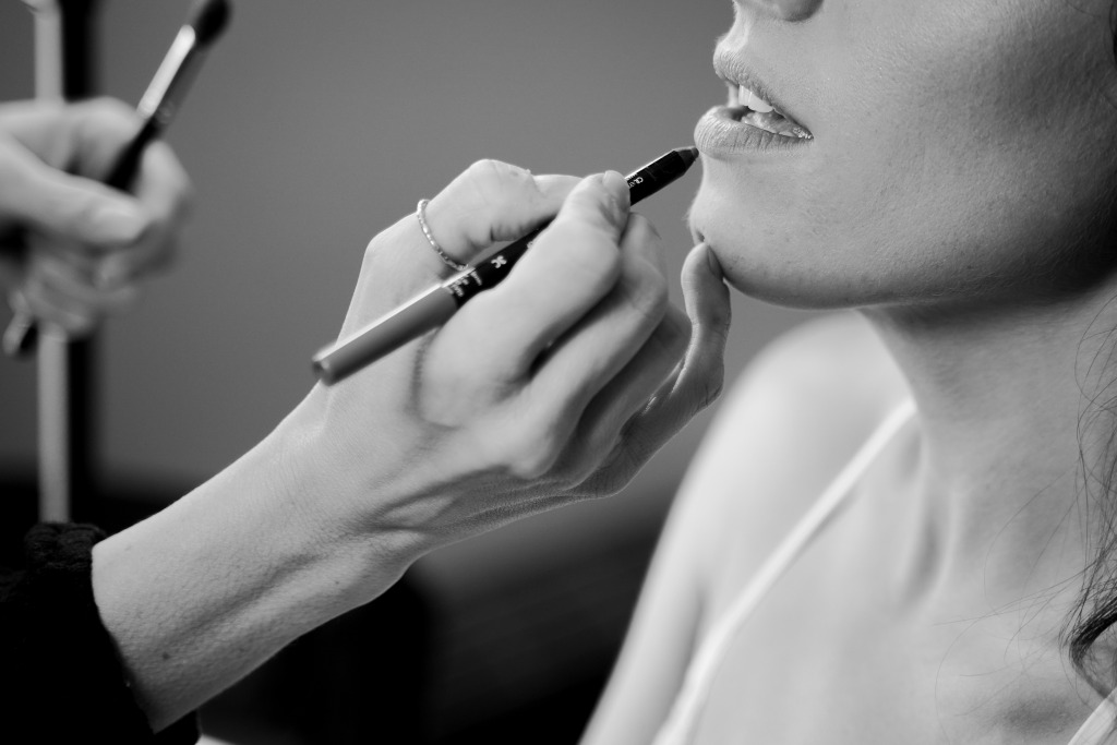 Makeup artist applying lip liner to Las Vegas Bride