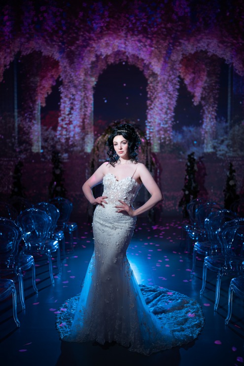 Brilliant Bridal Wedding Dress photographed by Luxlife LV at the Illuminarium. Purple and blue floral background.
