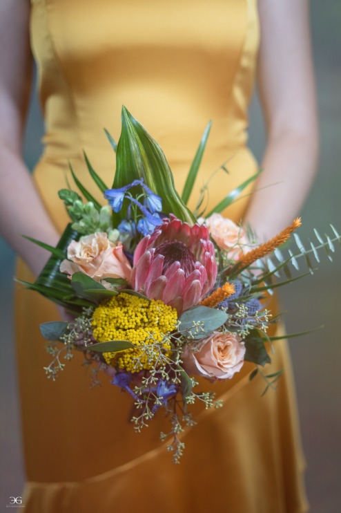 Beautiful floral bouquet held by bridesmaid in yellow at Las Vegas Wedding Photo Shoot