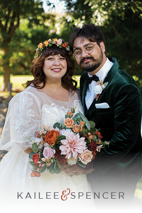 Beautiful Plus Size Bride and Groom get married in a garden in Las Vegas wearing a velvet green tuxedo and a sleeved dress with flower crown.
