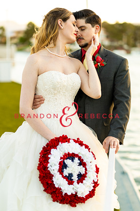 Love the nerdy details in this Marvel inspired wedding. The bride to be even has a captain america wedding bouquet that she made herself. She holds it as she poses with her husband in front of Lake Sahara in Las Vegas.