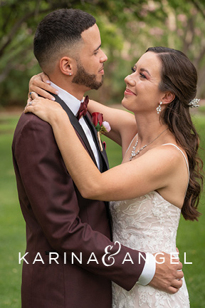 Karina and Angel's Las Vegas wedding at The Grove. Angel wear's a burgundy tux and his beautiful bride looks at him lovingly on their wedding day.
