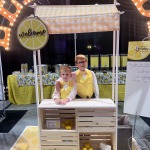Charlie and Ty posing in their lemonade stand at our Las Vegas Bridal Show, Bridal Spectacular.