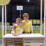 Charlie and Ty posing in their lemonade stand at our Las Vegas Bridal Show, Bridal Spectacular.