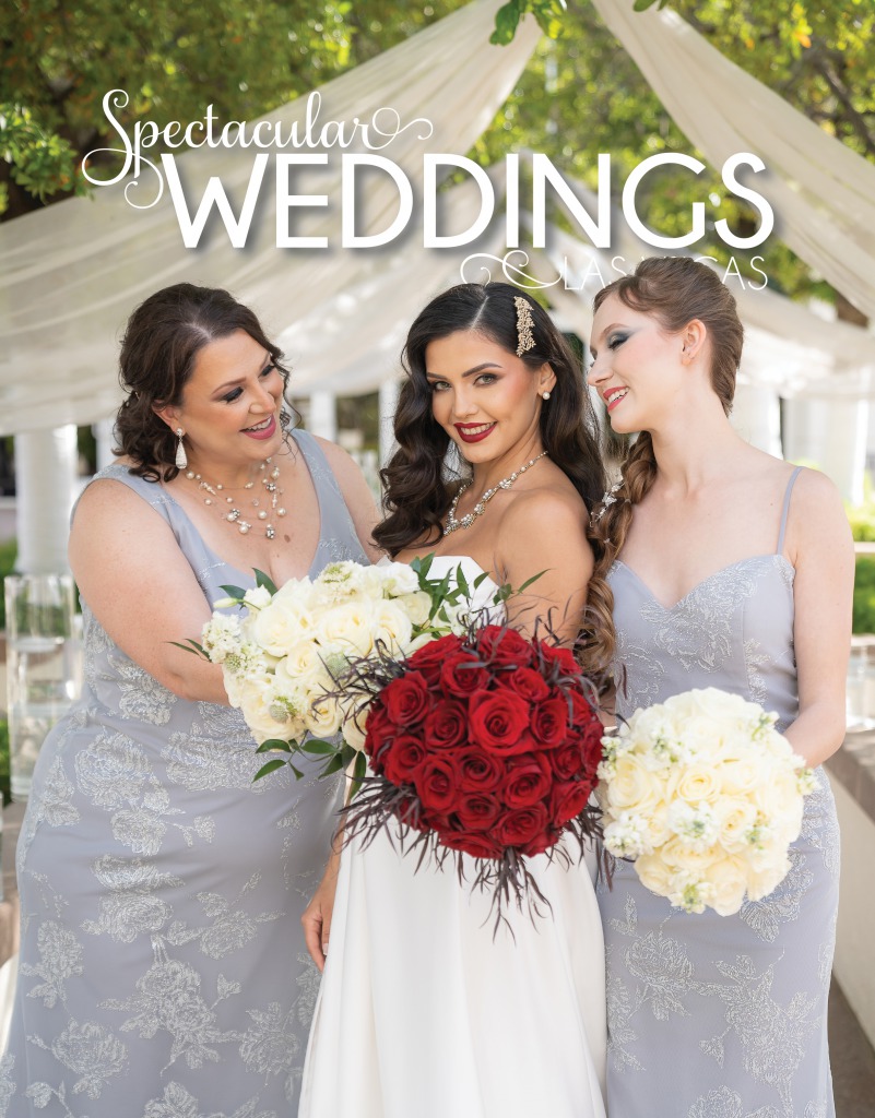 A Bride and her two bridesmaids in silver gowns show off their wedding bouquets