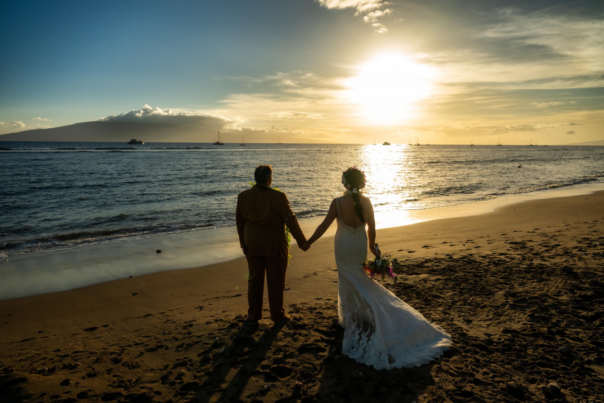 Ty and Ying pose in front of a lovely Maui sunset after their Lahaina Destination Wedding
