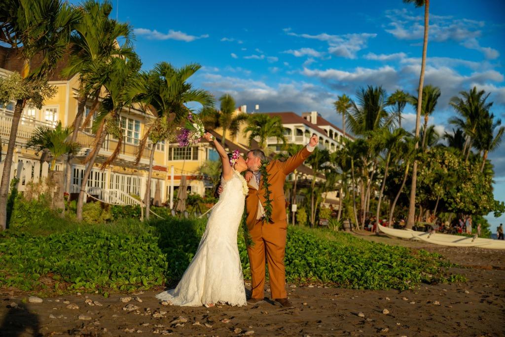 Ty and Ying in front of The Feast at Lele luau in Lahaina, Hawaii for their Destination Wedding.