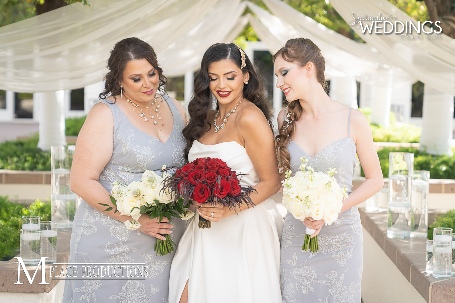 Beautiful plus size bridesmaid and petite bridesmaid in silver dresses with the bride look at their wedding bouquets in Las vegas