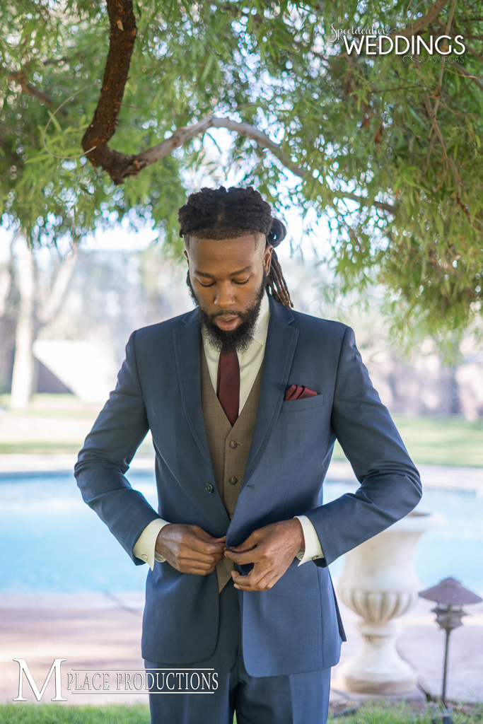 Blue suit with tan vest and burgundy accessories is a stunning look for a daytime wedding.